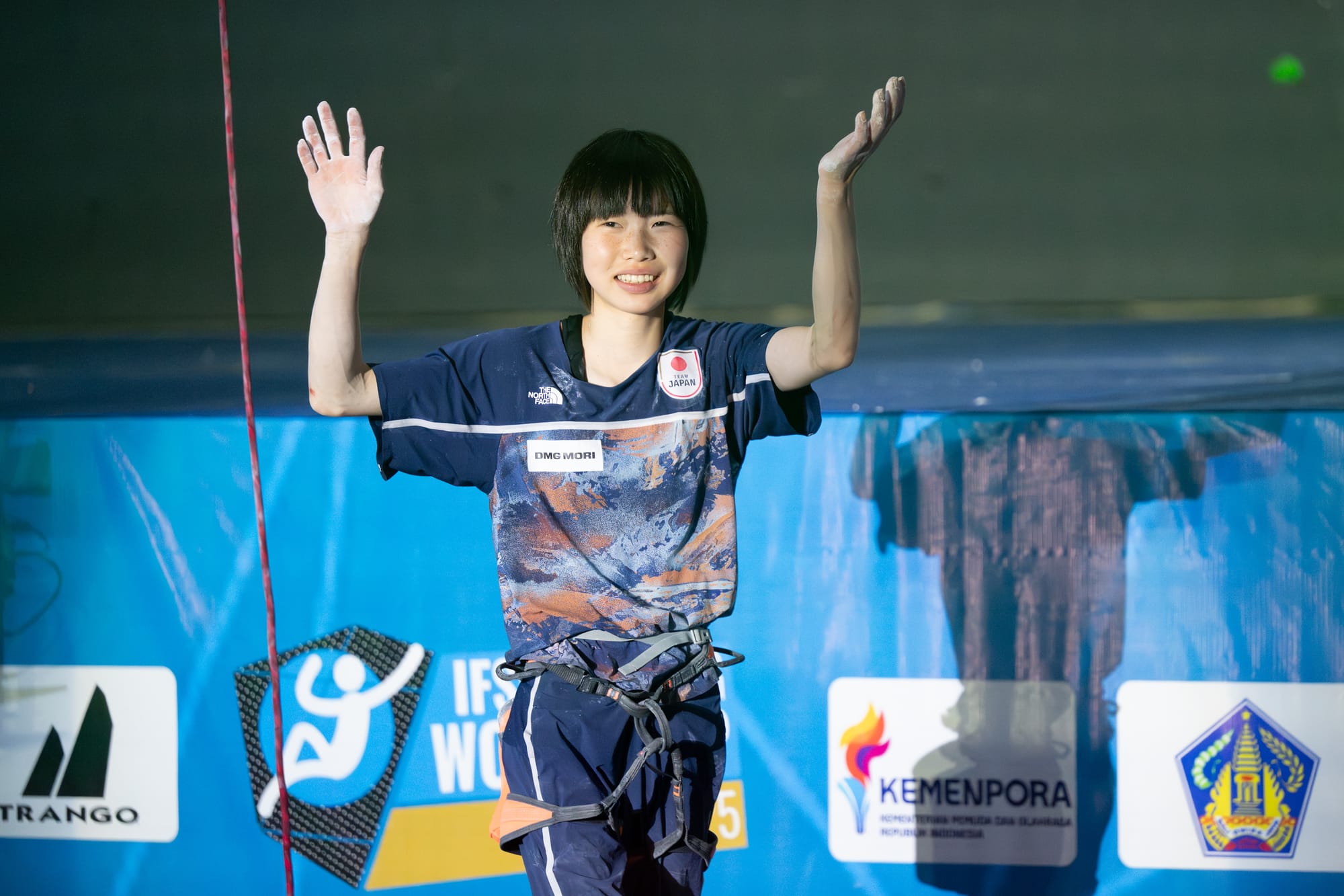 Ai Mori waves to the crowd after her climb