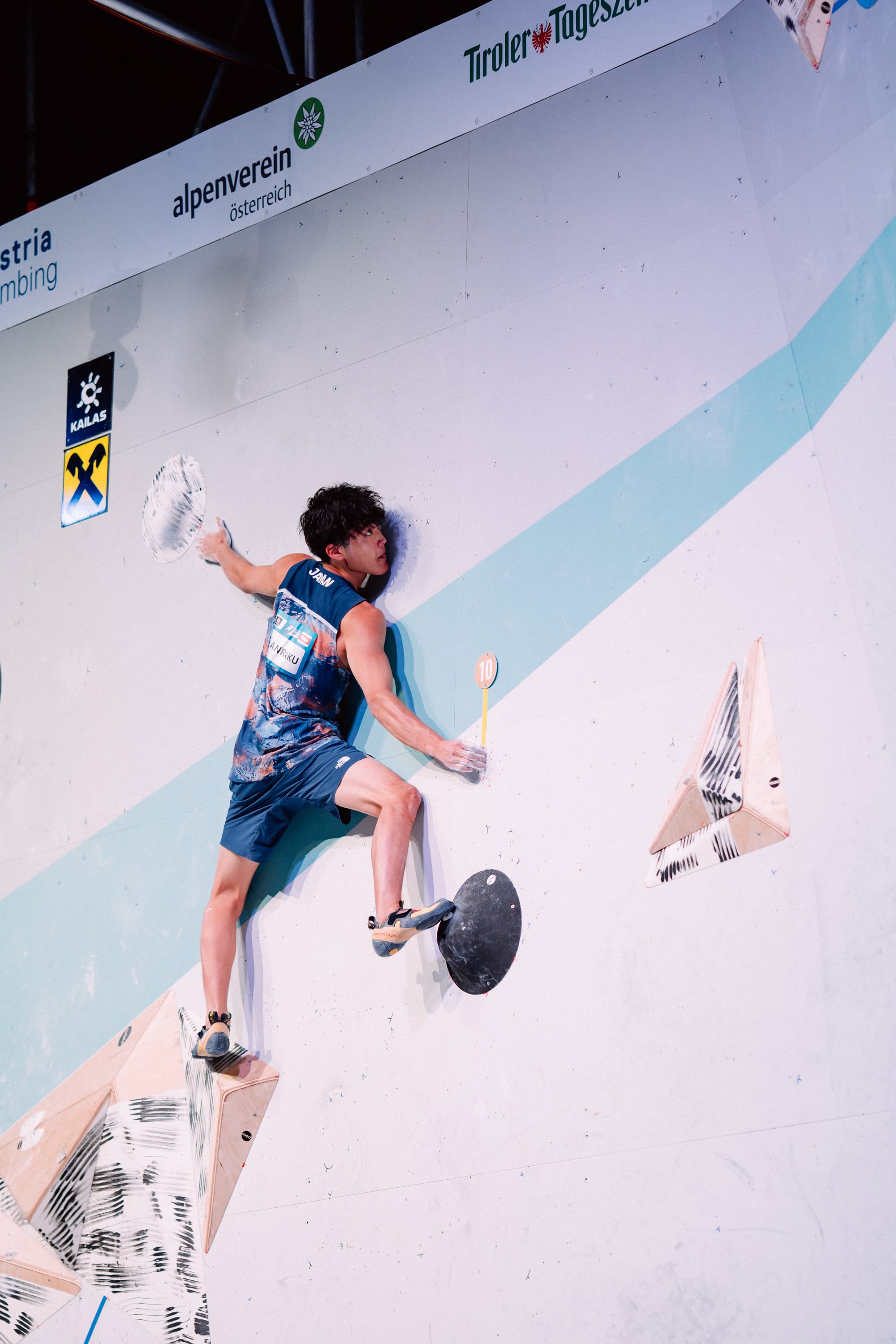 Sorato Anraku on the 3rd slab boulder in the final, holding the zone hold.