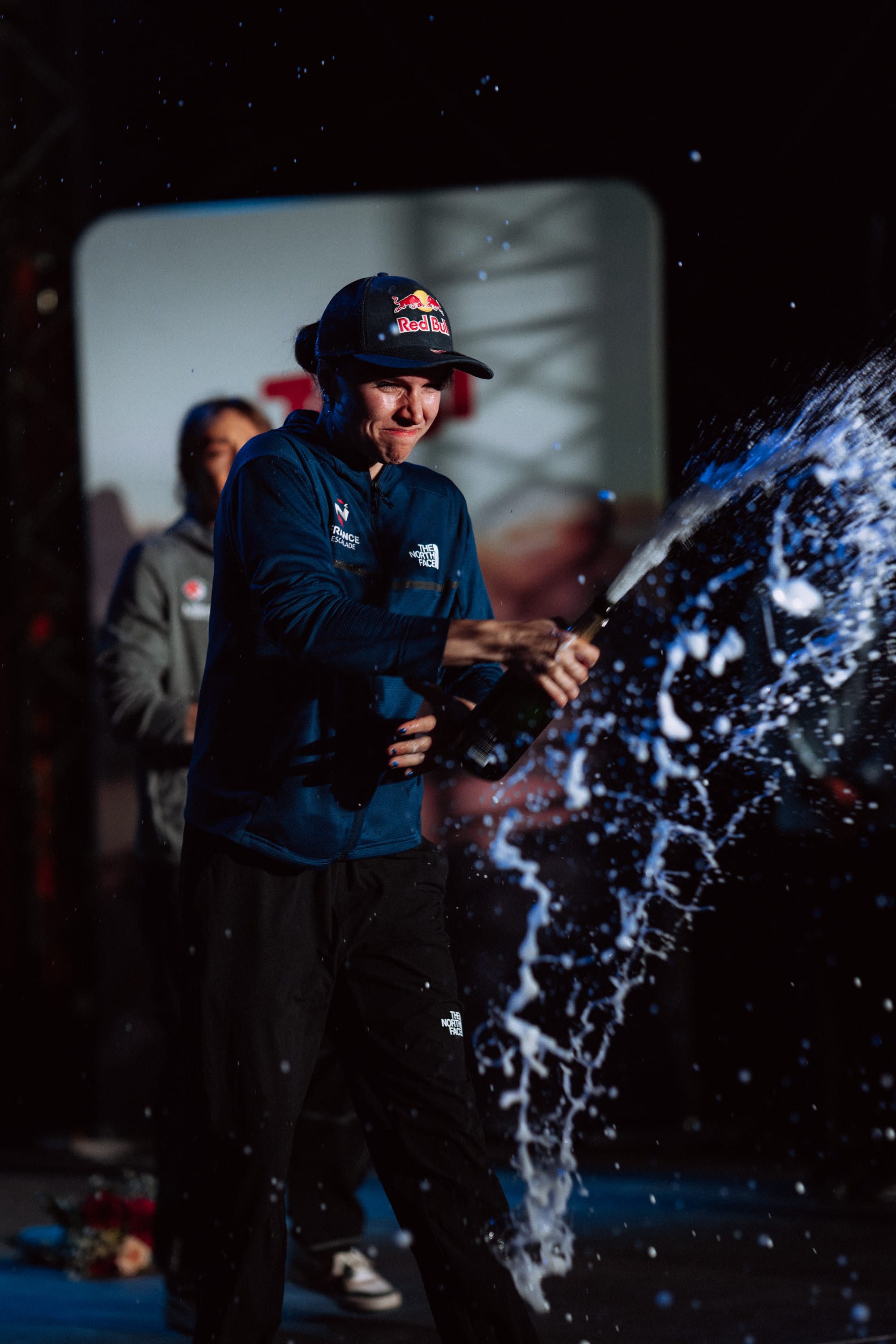 Oriane celebrating her overall win with champagne